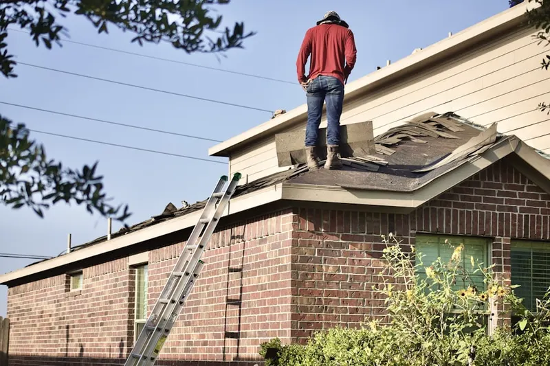 Professional roofer working on a residential roof in Wrights Mill